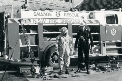 black and white picture of a fire brigade rescue truck and two fire fighters in protective clothing, Gray Street, 29th May 1988